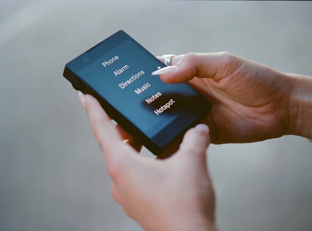 Collection of minimalist dumb phones including Light Phone III and Nokia 3210 for digital detox in 2026